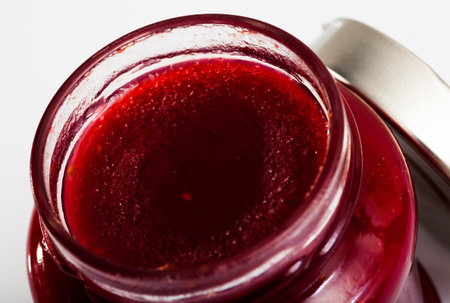 Closeup of raspberry jam in glass jar