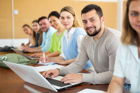 Man studying with group of students in university