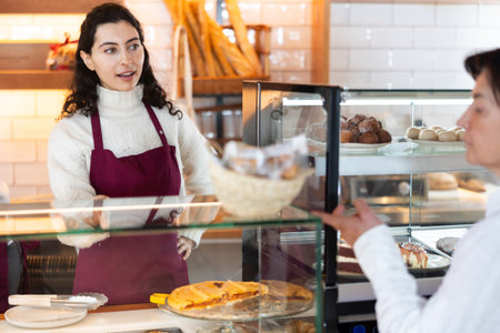 Woman seller offering pastries and coffeeの写真素材