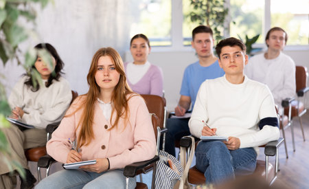 Group of high school students listening to lecture in auditoriumの写真素材
