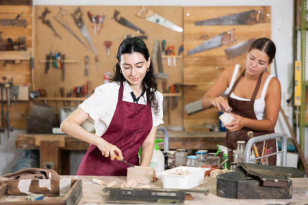 Girl working with wood in carpentry workshopの写真素材