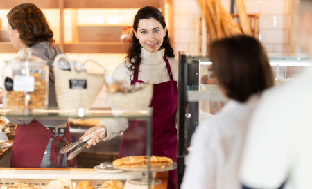 Woman folding fresh pastries