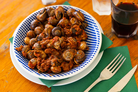 Snails with minced meat and tomatoes. Mediterranean dishの写真素材