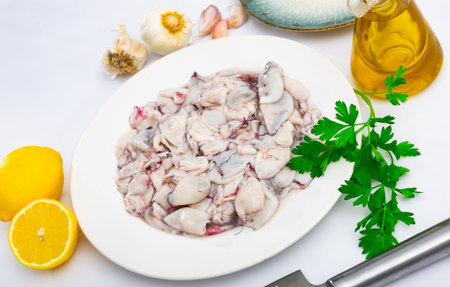 Raw squid, cut into pieces, will be an excellent side dish for lunch with lemon and garlic.