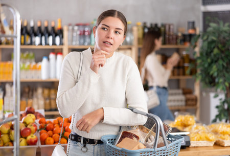 Young woman choosing groceries in the supermarketの写真素材