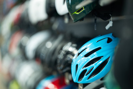 Sport goods store interior with colorful bicycle helmets on shelvesの写真素材
