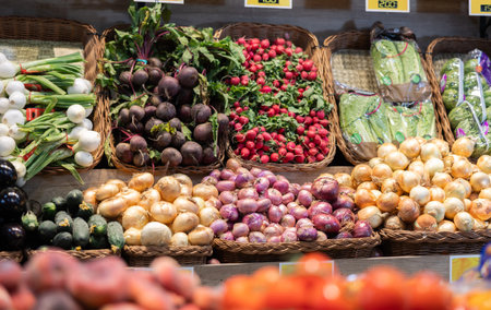 Row of display cases filled with vegetables in store