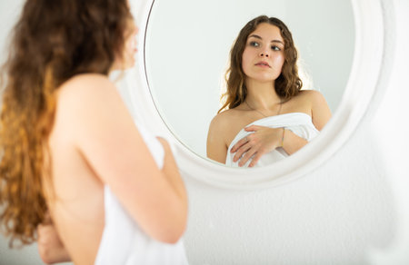 Girl in lingerie looks at herself in mirrorのeditorial素材