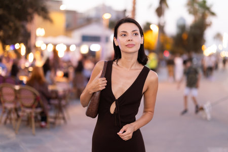 Smiling girl walks around old city district Barceloneta, pedestrian promenade embankment.の写真素材