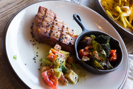 Grilled tuna steak with avocado and tomatoes