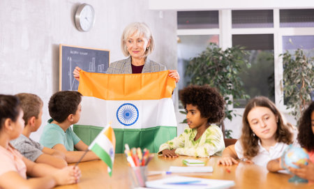 Friendly woman teacher tells pupils the history of India