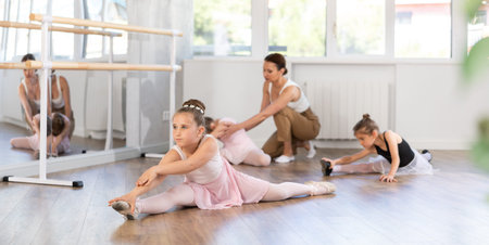 Group of girls doing splits in studio