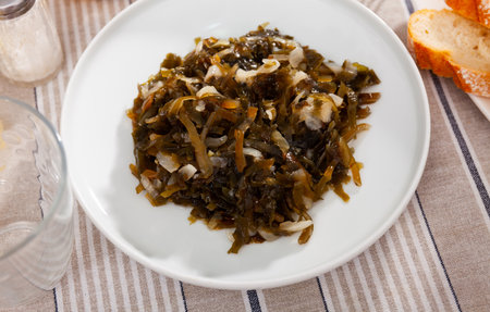 Marinated seaweed salad with onion served in plate. Asian cuisineの写真素材