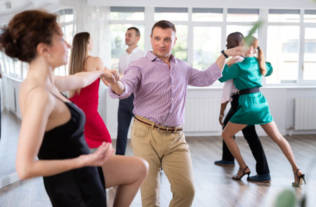 Woman dances boogie woogie with man partner during choreography lesson