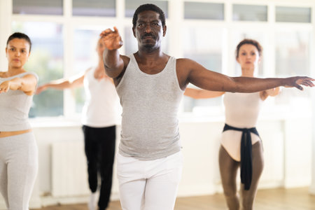 African American man practicing ballet movements in choreography studioの写真素材