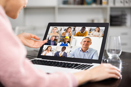 Woman talking with her colleagues via video call
