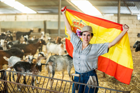 Portrait of happy female farmer in goat pen