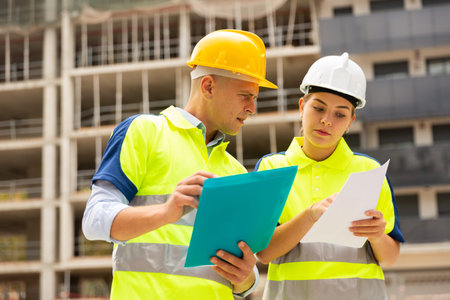 Two qualified engineers are discussing a construction plan
