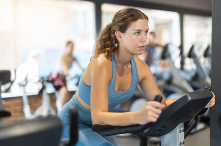 Woman exercising on an exercise bike in the gym