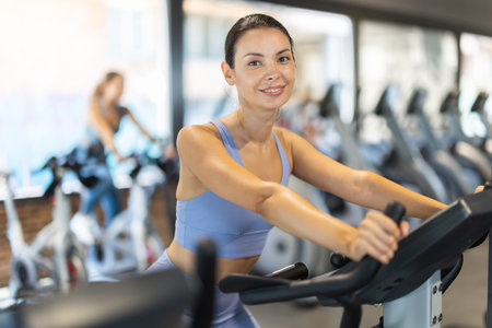 Woman exercising on an exercise bike in the gym