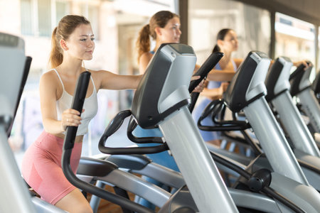 Woman training on elliptical machine