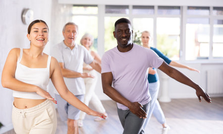 African American man practicing vigorous dance during group class