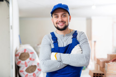 Portrait of a builder standing on a construction siteの写真素材