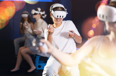 Young woman immersed in virtual reality game in gaming center