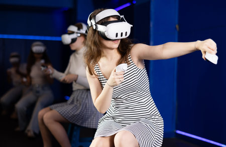Young woman immersed in virtual reality game in gaming center