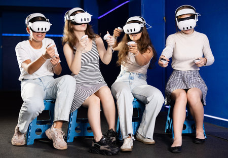 Girls using virtual reality glasses - friends having fun with vr headsetの写真素材