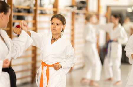 Women in kimono exercising in pairs during trainingの写真素材
