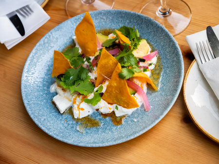 Mexican style salad with burrata, greens, avocado, tortilla chips