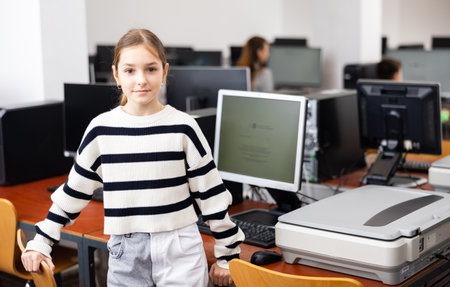 Portrait of schoolgirl girl in computer class at schoolの写真素材