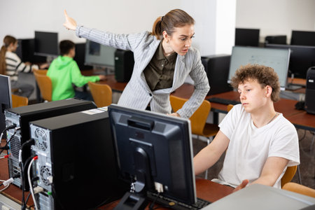 Teacher shouting at teenage boy during lesson
