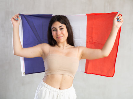 Young woman with flag posing in studioの写真素材
