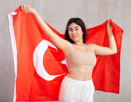 Young woman with Turkey flag posing in studioの写真素材