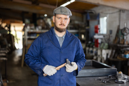 Young male worker posing in workshop