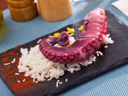 Slate of appetizing boiled octopus with riceの写真素材