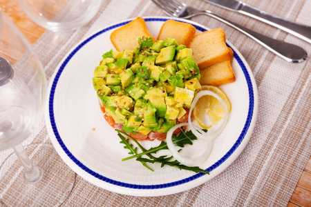 Salmon tartare with avocado and toasted breadの写真素材