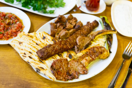Roasted red meat served on plate with flatbreadの写真素材