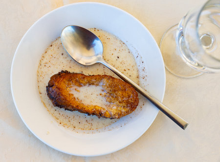 Traditional Spanish Holy Week Torrija de leche with creamy sauceの写真素材
