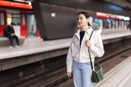 Portrait of woman at metro station waiting for trainの写真素材