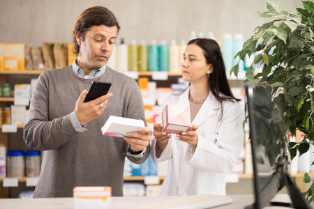 Man buyer scans pills qr code with woman pharmacistの写真素材