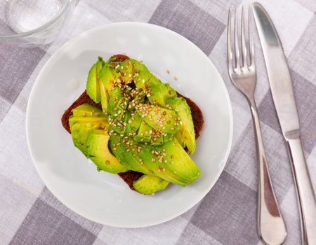 Delicious vegan sandwich with avocado and seeds