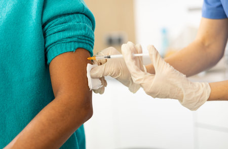 Female nurse vaccinating patient