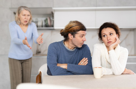 Elderly woman swears at married coupleの写真素材