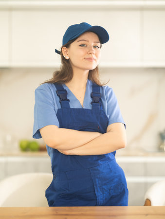Young woman worker at table in kitchenの写真素材