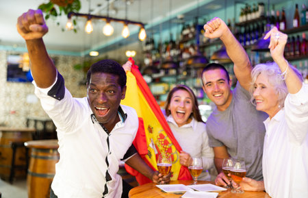 Happy fans celebrating the victory of Spanish team in barの写真素材