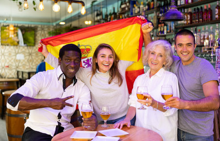 Joyful fans of the Spain team celebrating the victory in night barの写真素材