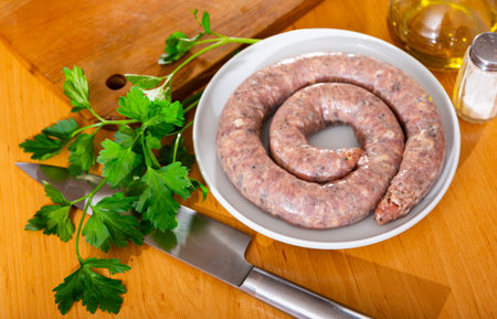 There is ring of homemade raw sausage made from meat mixの写真素材